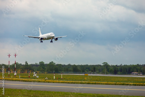 white passenger plane lands at the airport