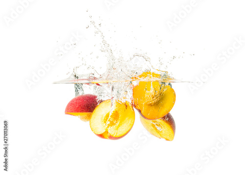 Fototapeta Naklejka Na Ścianę i Meble -  Fresh Nectarine with water splash over white background