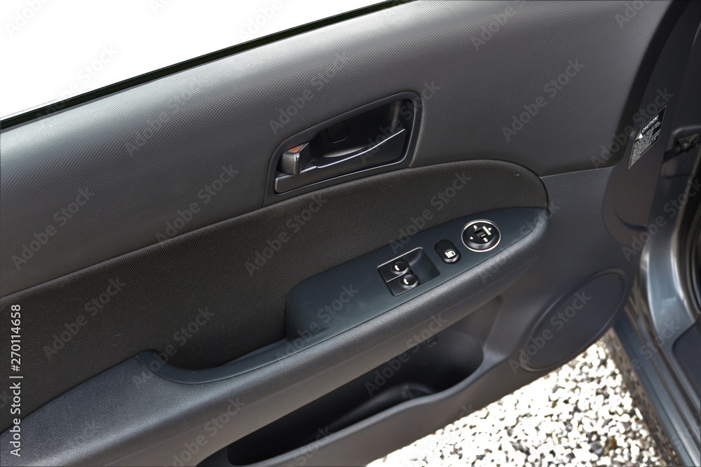 Car door handle with adjustment knobs.