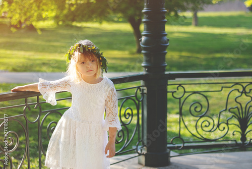 Beautiful little girl with flower wreath on her head, on Lazarus saturday photo