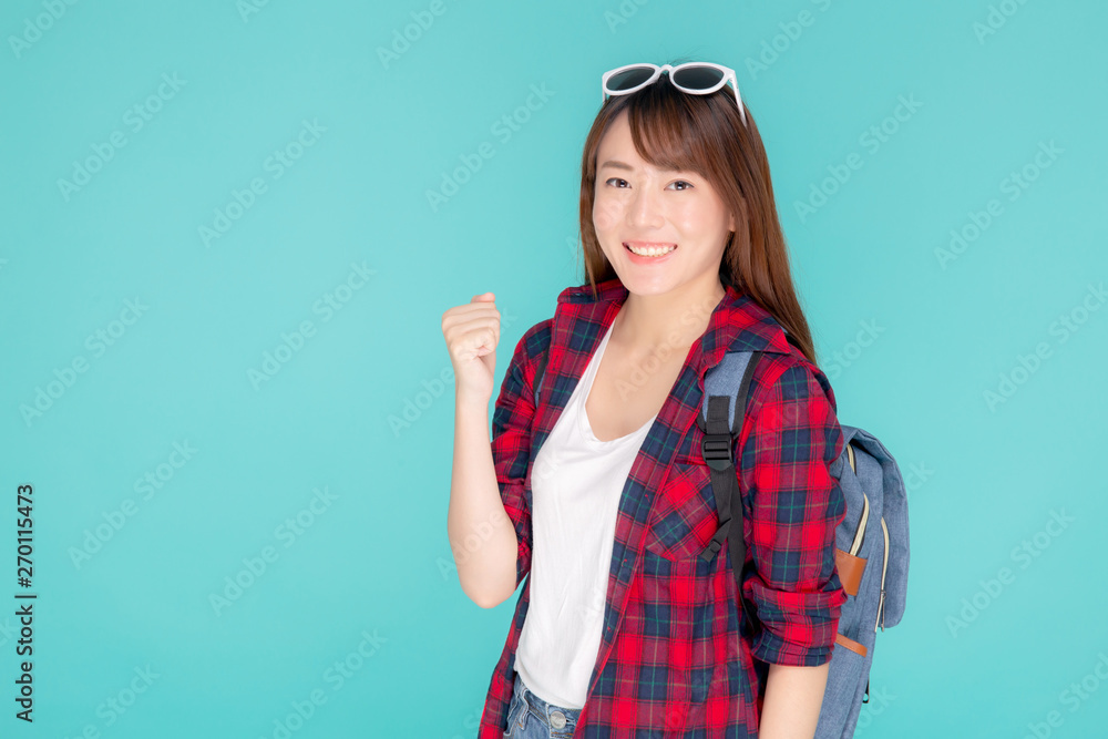 Fototapeta premium Beautiful portrait young asian woman wear sunglasses on head smile confident and excited summer holiday isolated blue background, model girl fashion having backpack, travel concept.