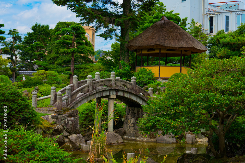 A cute stone bridge in Japanese garden A cute stone bridge in Japanese garden