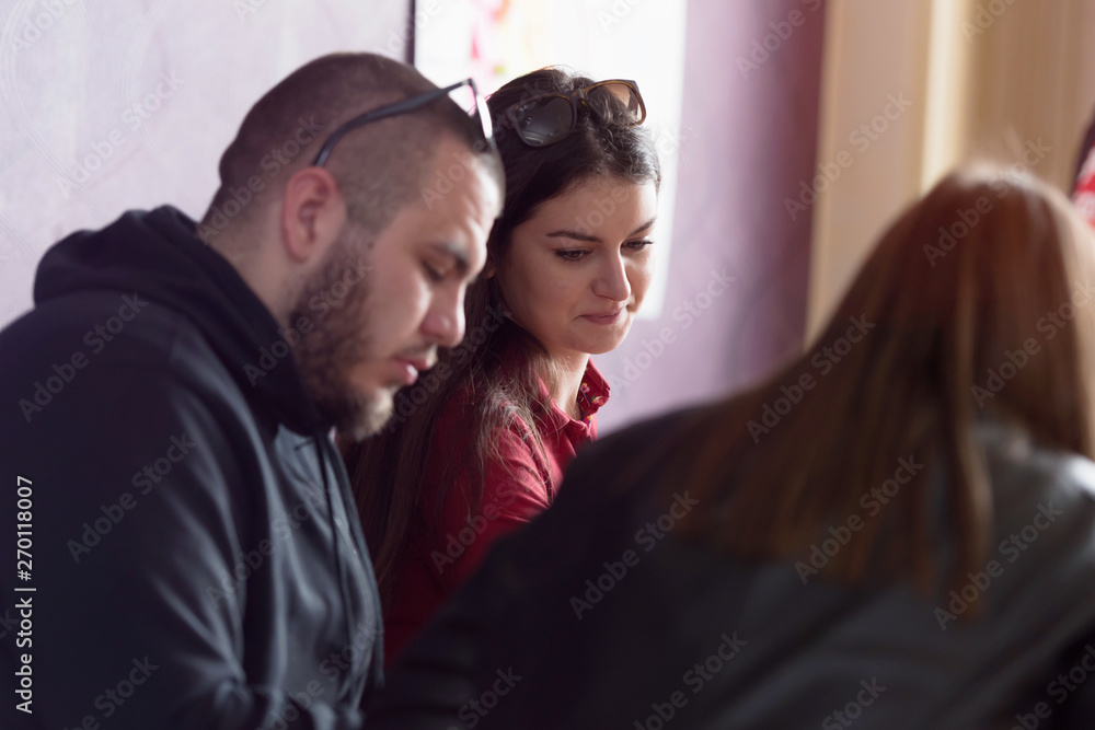 Group of young female talented designers looking at innovative project suggesting creative solution to client, brainstorming for ideas. Group of young female talented designers looking at innovative project suggesting creative solution to client, brainstorming for ideas.