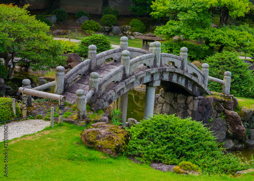 A cute stone bridge in Japanese garden 