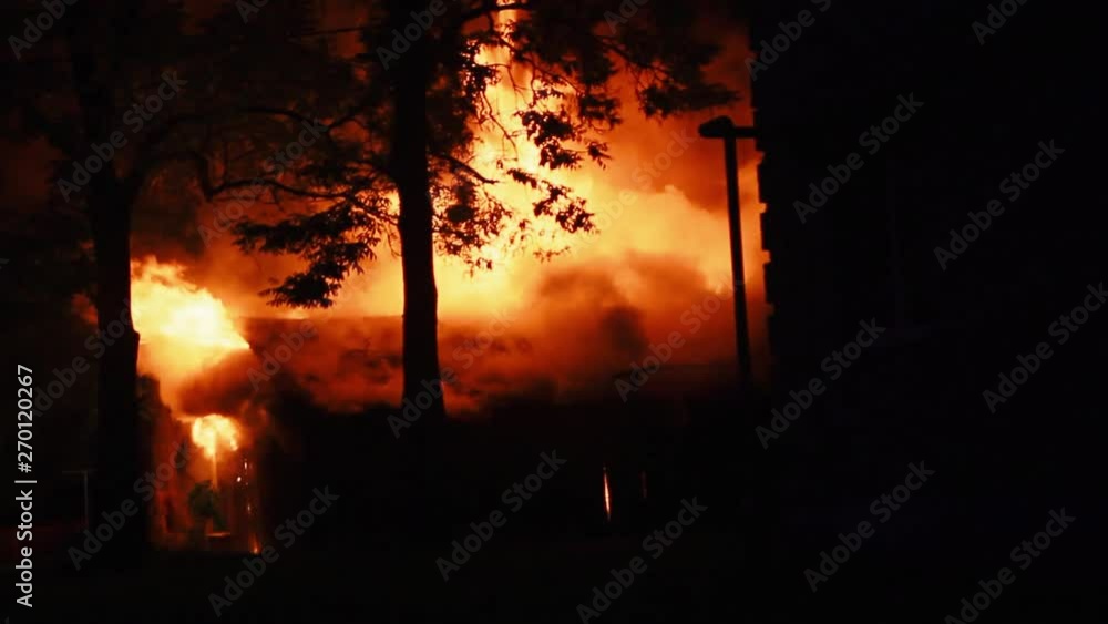 fire in the house. male firefighter puts out the flames fire in the house. male firefighter puts out the flames