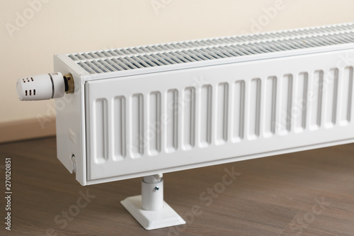 Wallpaper Mural heating radiator with thermostatic knob in the living room Torontodigital.ca