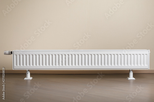 Wallpaper Mural heating radiator with thermostatic knob in the living room Torontodigital.ca