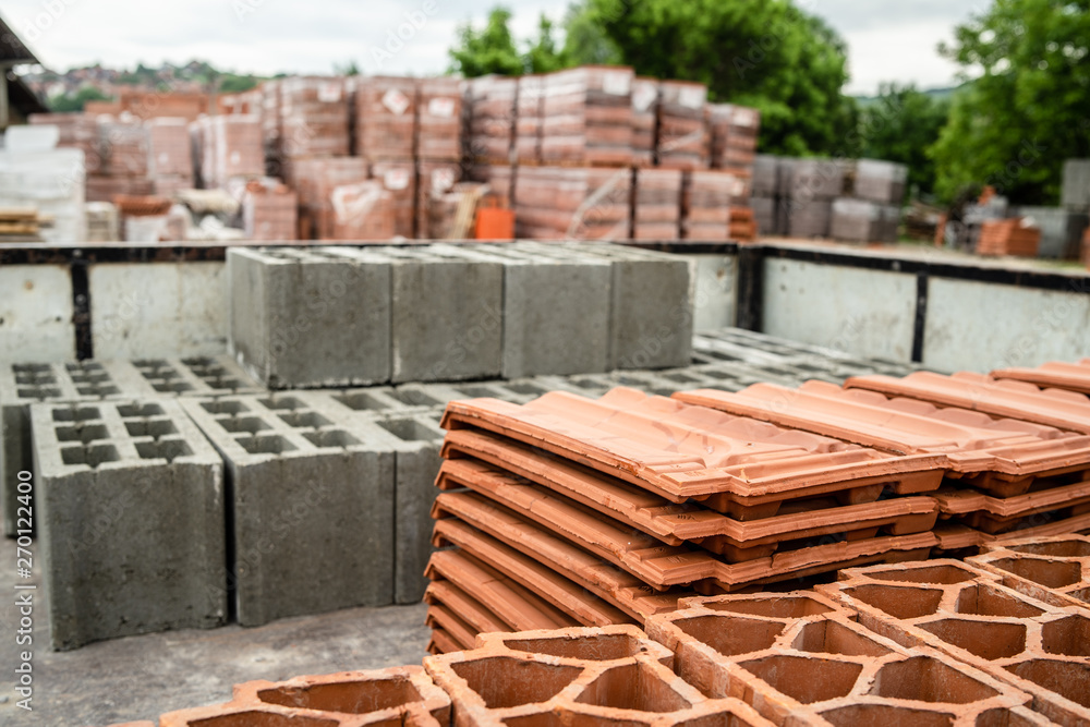 Clay tile and brick blocks concrete at the warehouse loaded in the back of the truck ready for the delivery to the construction site Clay tile and brick blocks concrete at the warehouse loaded in the back of the truck ready for the delivery to the construction site