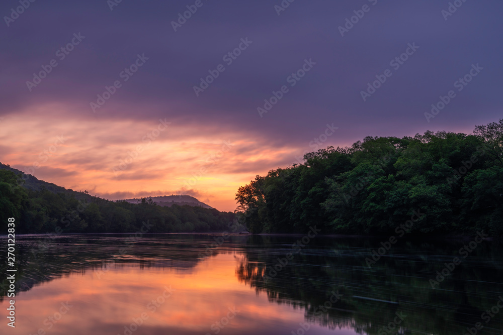 Moody sunrise over Delaware Water Gap, Pennsylvania featuring lake on the foreground and mountains on the background