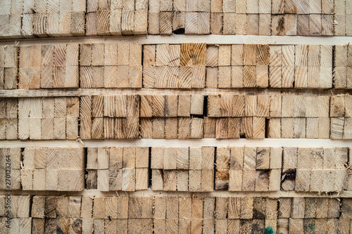 Tableau sur toile Close up on stack of rough sawn timber pine lumber construction material at the