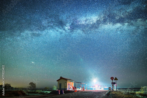 The starry sky above the house and railway.