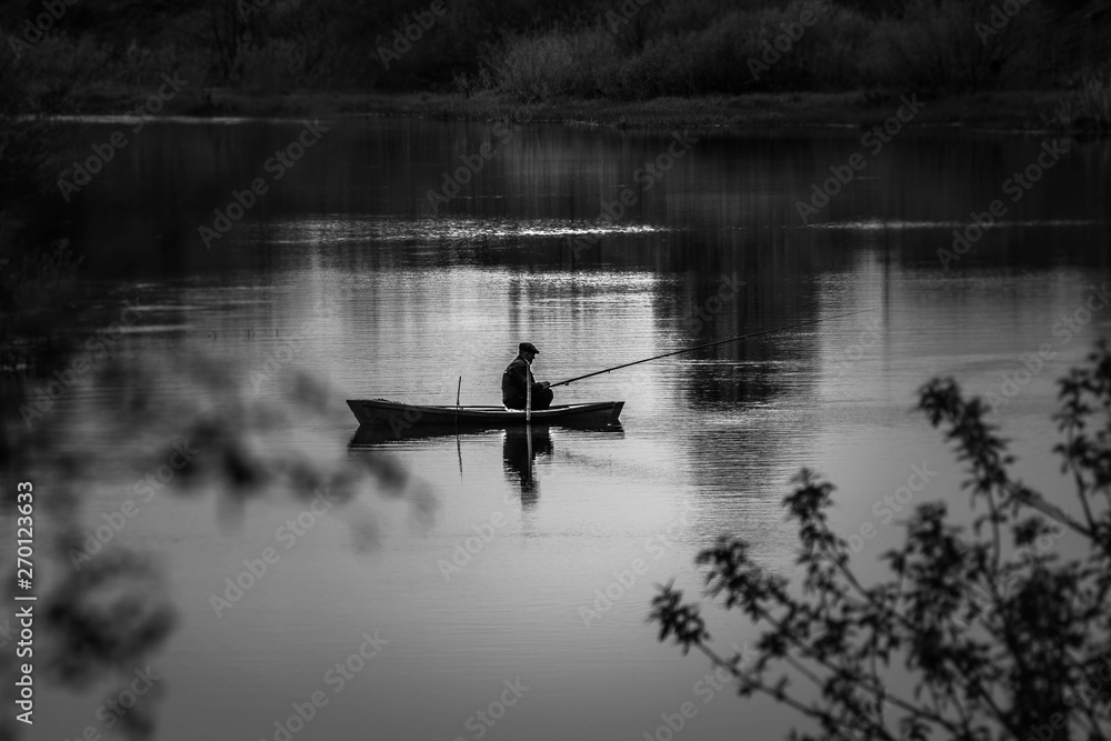 fisherman on a boat on the river to fish fisherman on a boat on the river to fish