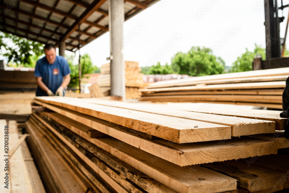 Close up on stack of rough sawn timber pine lumber planks construction material Close up on stack of rough sawn timber pine lumber planks construction material