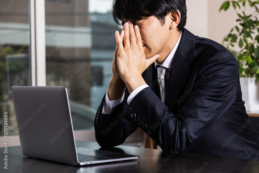 オフィスで悩む会社員 オフィスで悩む会社員