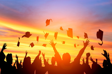 happy students throwing graduation caps in the Air