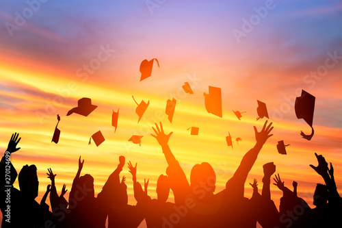 Photography happy students throwing graduation caps in the Air