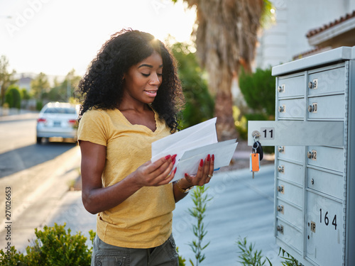 african american woman checking mail in las vegas community