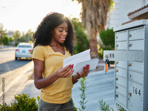 african american woman checking mail in las vegas community photo