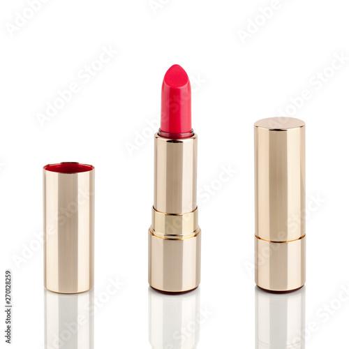Obraz na plátne Red lipstick in golden tube on white background with mirror reflection on glass