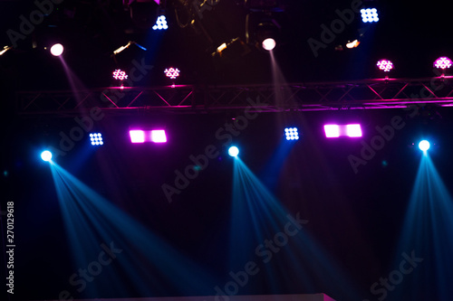 Fotografija Performance moving lighting on construction light beam ray downward in yellow blue color, on Concert and Fashion Show stage ramp