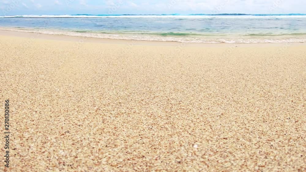 Background of sandy beach and sea, view on horizon, and walking past female feet in slow motion