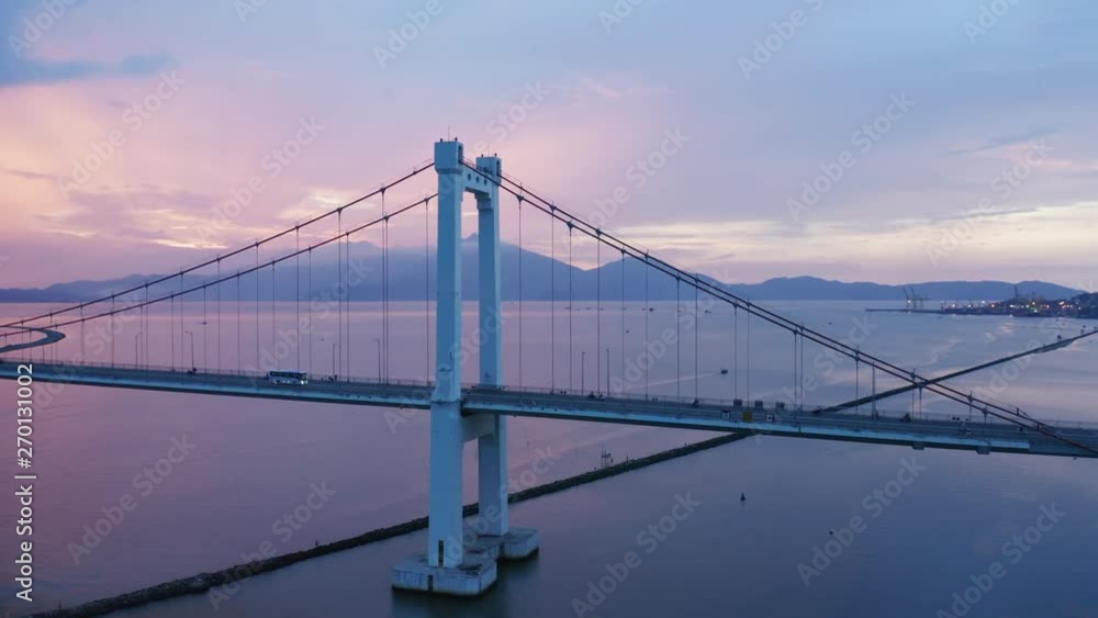 An aerial drone flight over a suspension bridge with mountains int he background. Filmed in Vietnam, Danang. An aerial drone flight over a suspension bridge with mountains int he background. Filmed in Vietnam, Danang.