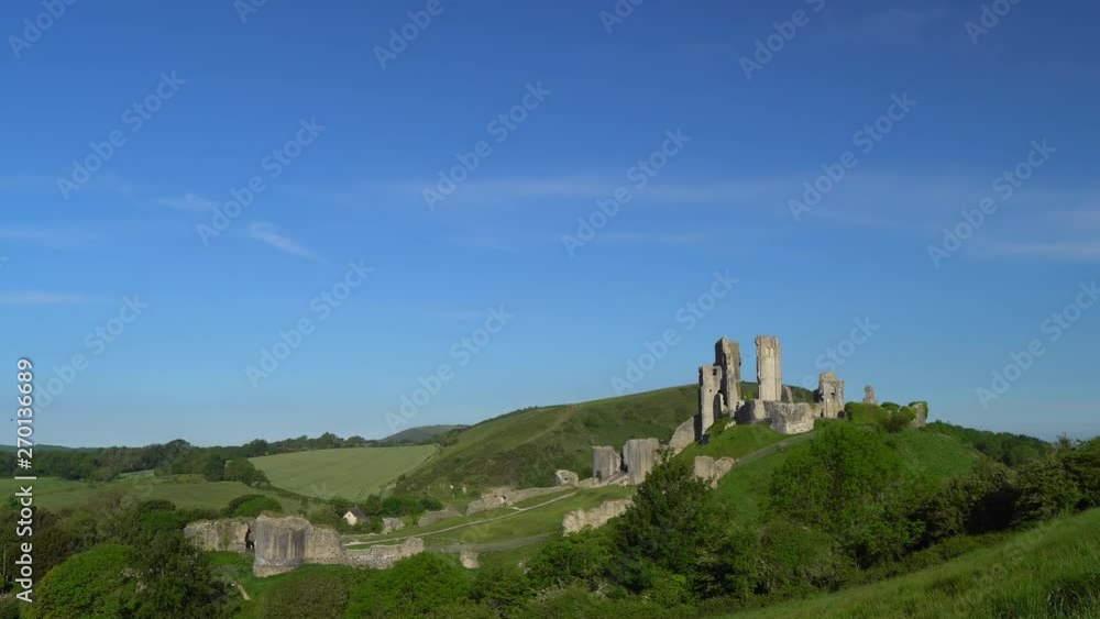 Pan and zoon shot of Corfe Castle in early morning light, Isle of Purbeck, Dorset, England. Pan and zoon shot of Corfe Castle in early morning light, Isle of Purbeck, Dorset, England.