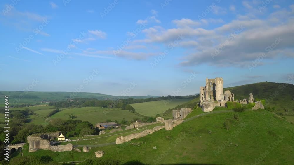Slow panning shot of Corfe Castle in early morning light, Isle of Purbeck, Dorset, England. Slow panning shot of Corfe Castle in early morning light, Isle of Purbeck, Dorset, England.