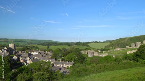 Slow panning shot of Corfe village and castle early morning, Isle of Purbeck, Dorset, England. photo