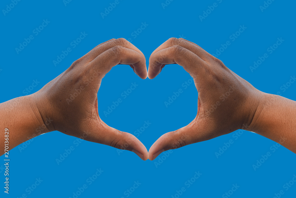 Obraz premium Man's hands make a heart shape. With a sky background