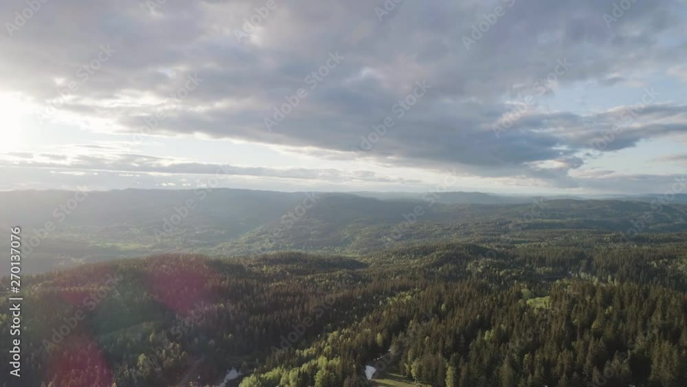 4K aerial with forward motion of the forest, valleys, cloudy blue sky and nature outside the Oslo city line in a beautiful and colorful sunset. 4K aerial with forward motion of the forest, valleys, cloudy blue sky and nature outside the Oslo city line in a beautiful and colorful sunset.
