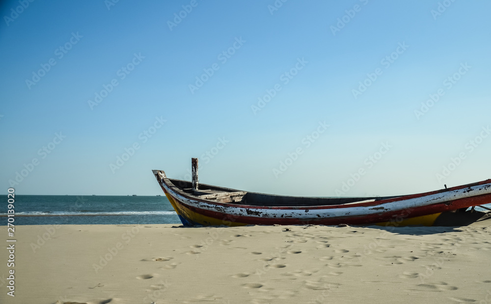single wood boat lying on the beach