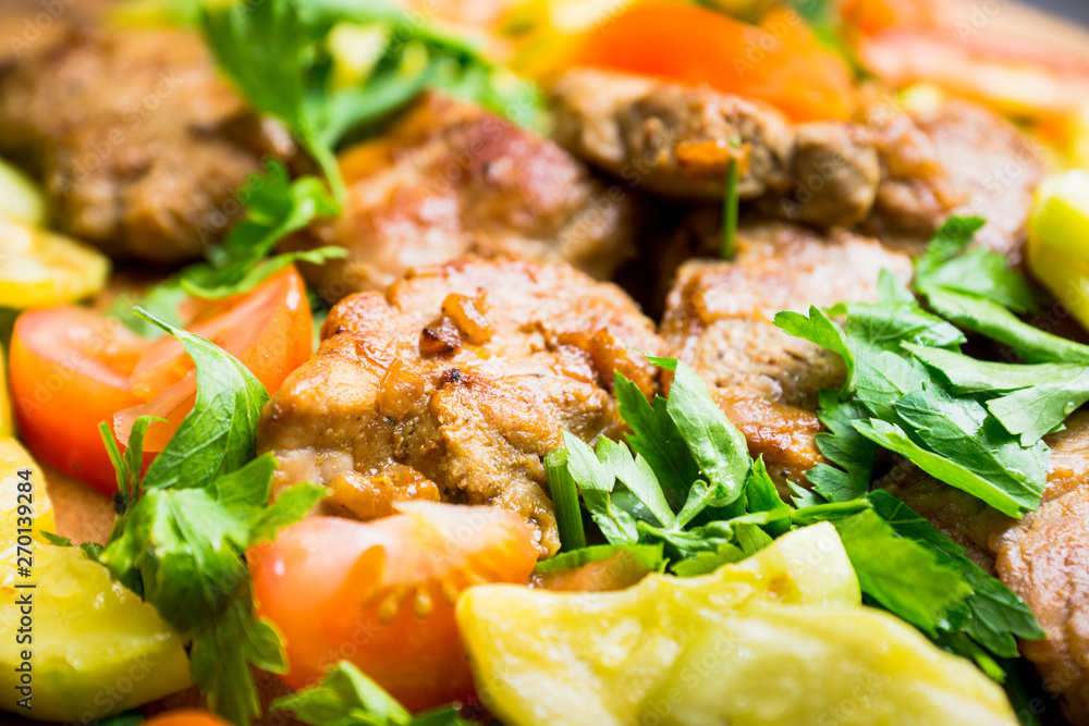 Grilled meat with vegetables on the wooden plate. Selective focus. Shallow depth of field. Grilled meat with vegetables on the wooden plate. Selective focus. Shallow depth of field.