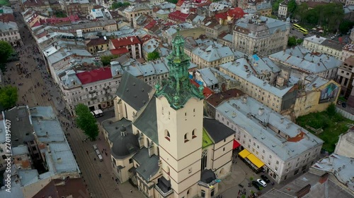 Flying near the town hall in the city of Lviv with rainy weather with clouds photo