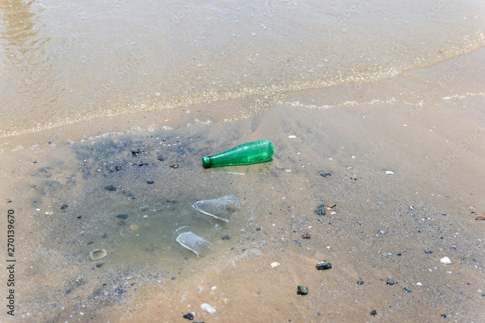 garbage and plastic bottles and dirty waste on a beach garbage and plastic bottles and dirty waste on a beach