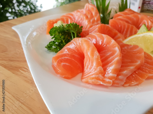 fresh salmon sliced in white dish.