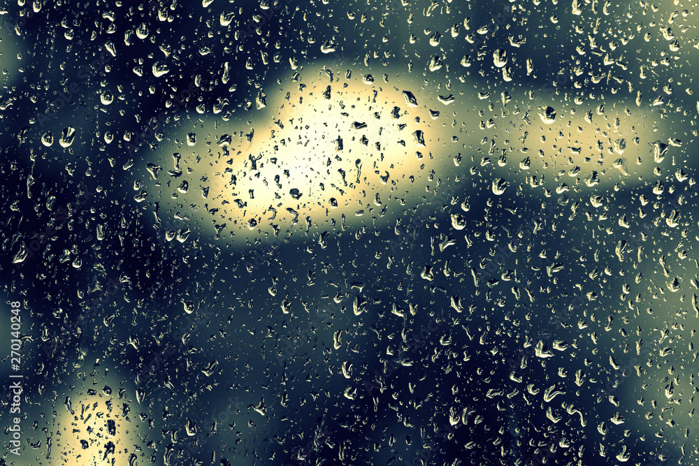 Fototapeta premium Water drops on glass during a rain close up. Natural background