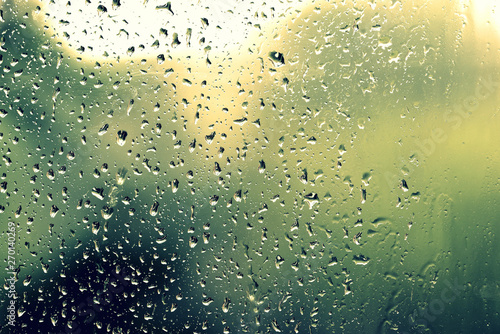 Water drops on glass during a rain close up. Natural background