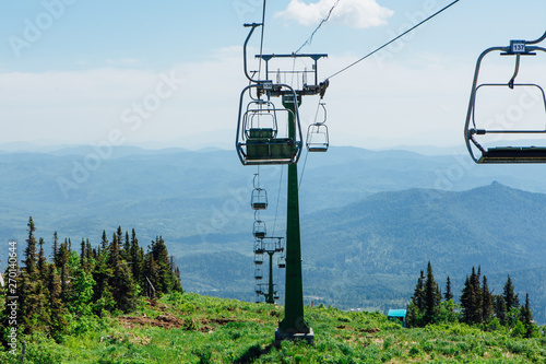 Empty chairs of ski lift at summer time