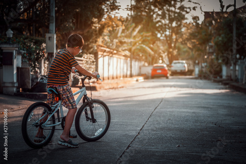 Asian boys practice cycling alone.