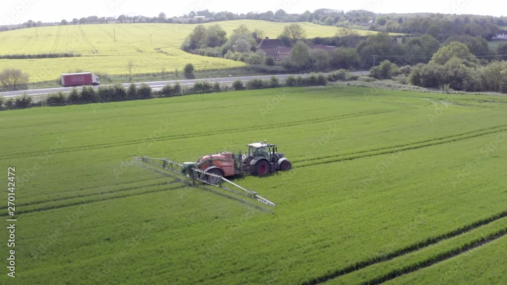 Tractor Spraying Fields on an Arable Farm with Glyphosate Herbicide