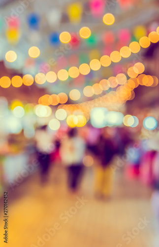 blur image of people in food festival with bokeh .