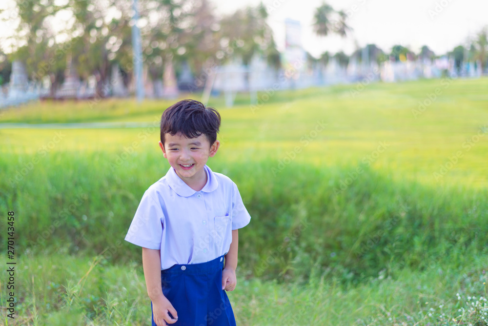 Outdoor portrait of a happy Asian student kid in school uniform smiling. Outdoor portrait of a happy Asian student kid in school uniform smiling.
