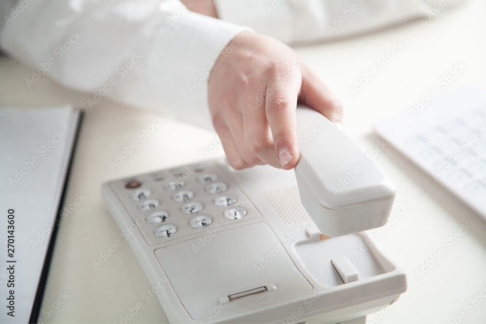 Office worker holding phone receiver. Office worker holding phone receiver.