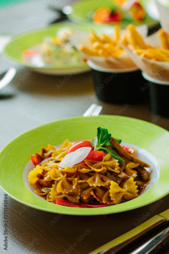 Farfalle pasta in a green plate. Farfalle pasta in a green plate.
