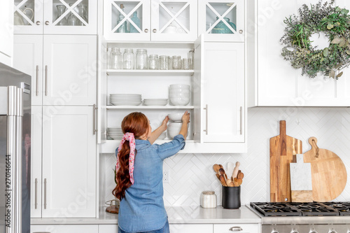 Farmhouse Kitchen Cabinet Full of Dishes photo