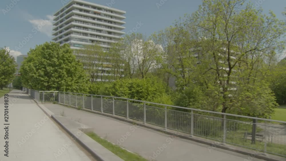 Steady moving shot of city green area from the bike lanes Steady moving shot of city green area from the bike lanes