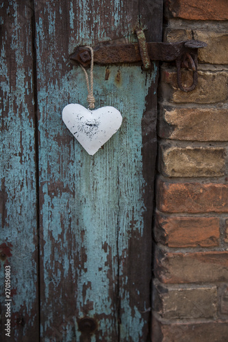 Metal Heart Hanging On Old Door Handle photo