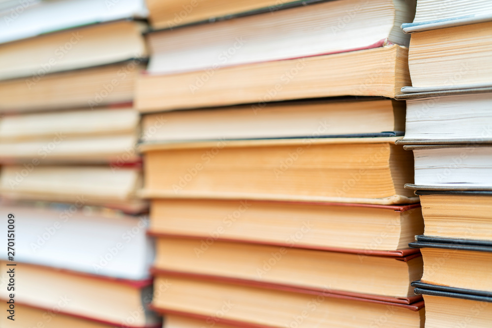 Rows of books in the library. Background for text. Symbol of knowledge and learning. Rows of books in the library. Background for text. Symbol of knowledge and learning.