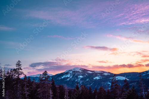 Winter mountain landscape with white snow and colorful sky photo